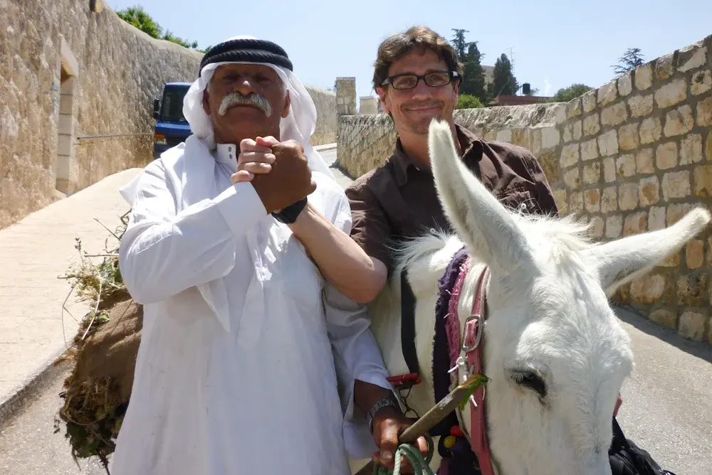 Shaking hands with a local and his donkey in Israel